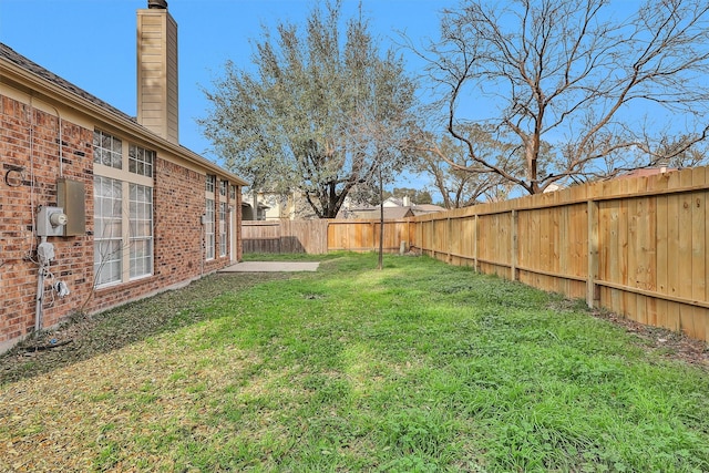 view of yard with a fenced backyard