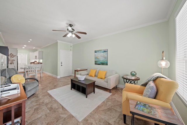 living room with a healthy amount of sunlight, baseboards, and crown molding