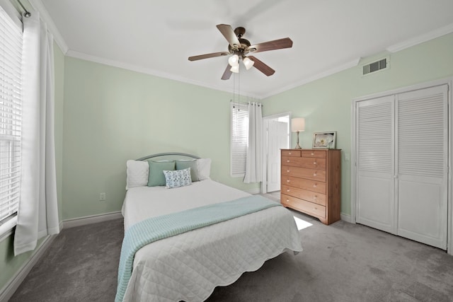 carpeted bedroom featuring baseboards, visible vents, a closet, and ornamental molding