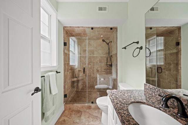 full bath featuring toilet, a stall shower, vanity, and visible vents