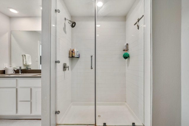 bathroom featuring a shower stall and vanity