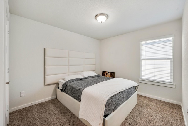 bedroom with carpet and baseboards