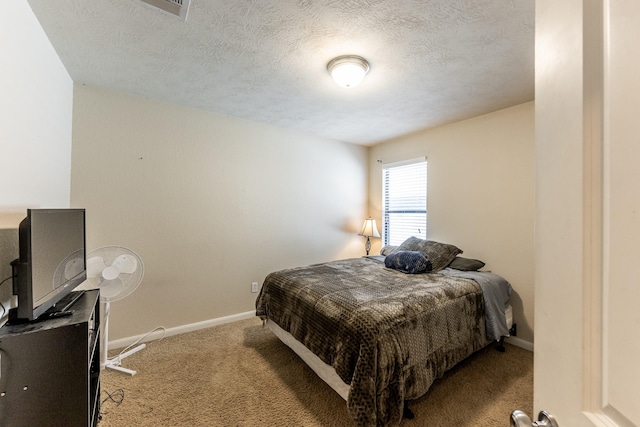 bedroom with carpet, visible vents, a textured ceiling, and baseboards