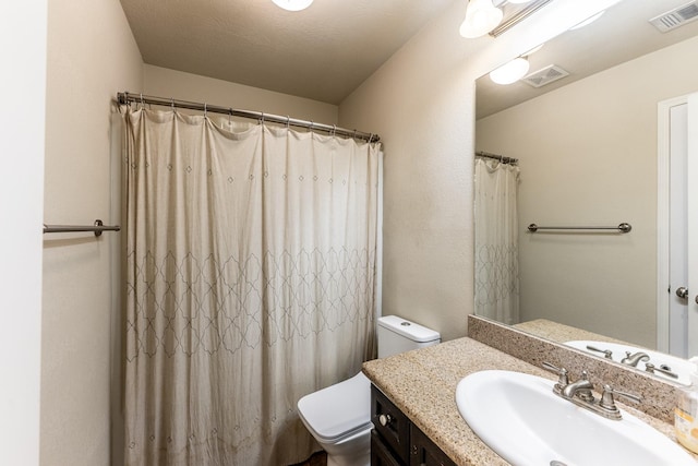 full bath with toilet, visible vents, and vanity