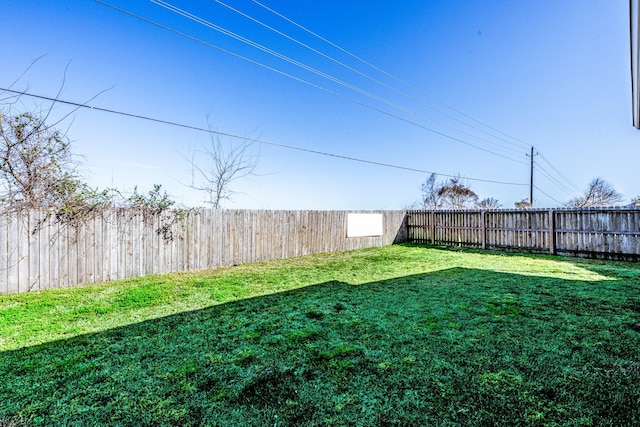 view of yard with a fenced backyard