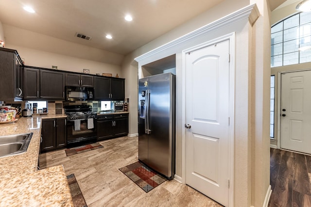 kitchen featuring recessed lighting, visible vents, light countertops, backsplash, and black appliances