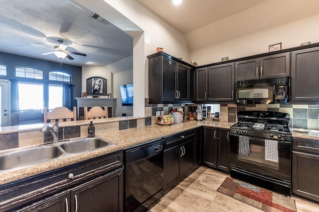 kitchen with black appliances, backsplash, a sink, and visible vents