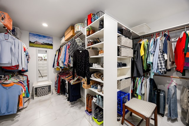 spacious closet featuring attic access