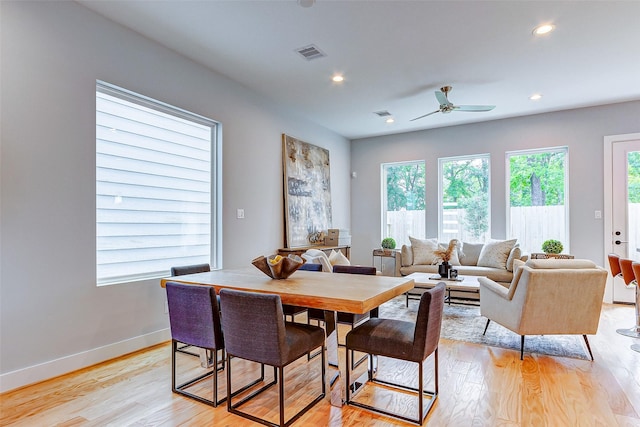 dining space with light wood-style flooring, recessed lighting, visible vents, and baseboards