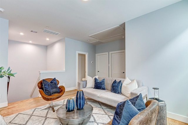 living room featuring recessed lighting, wood finished floors, visible vents, and attic access