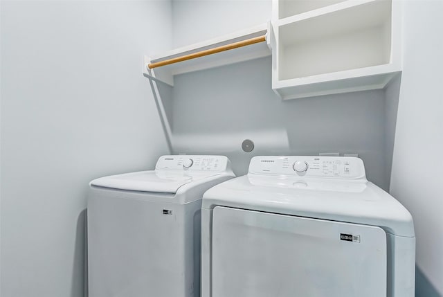 clothes washing area featuring laundry area and washing machine and clothes dryer