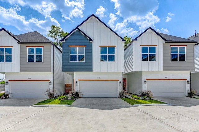 view of front of home featuring a garage, concrete driveway, and board and batten siding