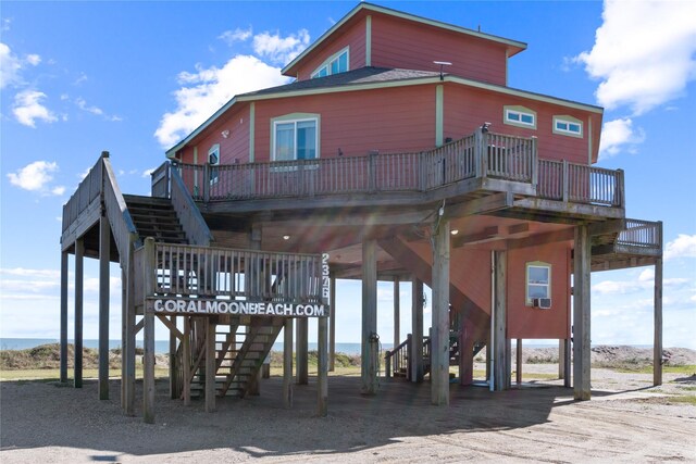 exterior space with a carport, a deck, and stairs