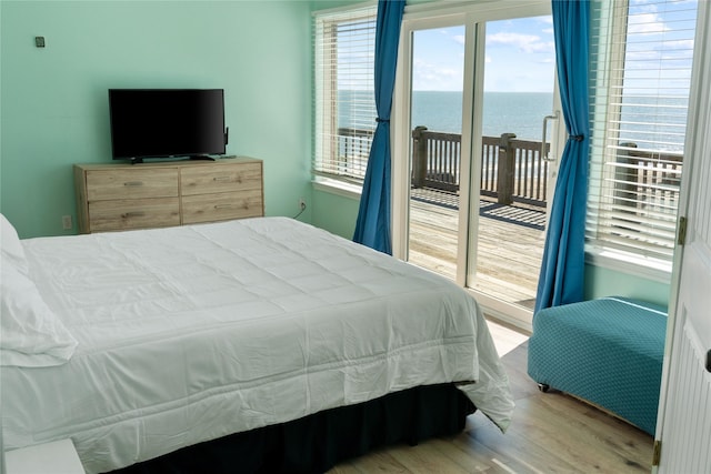 bedroom featuring access to outside and wood finished floors