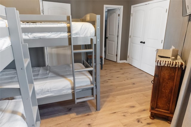 bedroom featuring light wood-style floors and a closet
