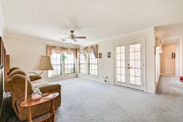 living area with carpet floors, french doors, crown molding, and a textured ceiling