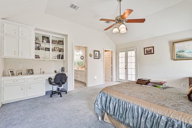 bedroom featuring light carpet, visible vents, vaulted ceiling, french doors, and built in study area