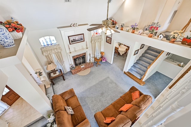 carpeted living area featuring stairs, high vaulted ceiling, a fireplace, and visible vents