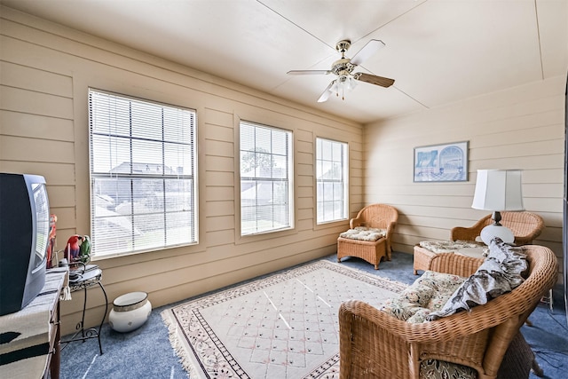 sitting room featuring a ceiling fan