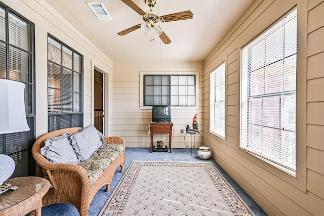 sunroom / solarium with visible vents and ceiling fan