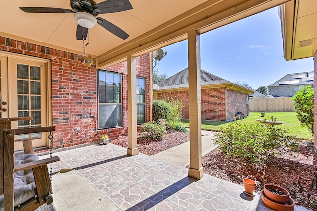 view of patio featuring ceiling fan and fence