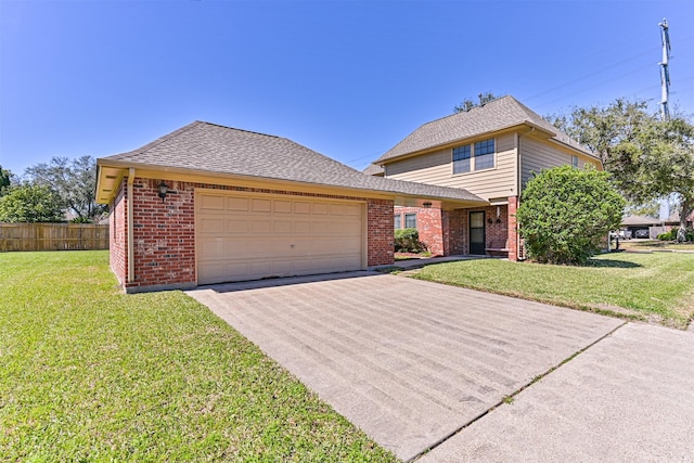 traditional-style home featuring a garage, brick siding, fence, concrete driveway, and a front yard