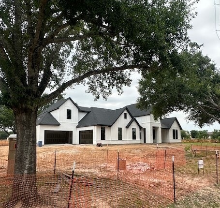 8533 Bois Darc Ln, Richmond, TX 77406 - modern farmhouse featuring a garage