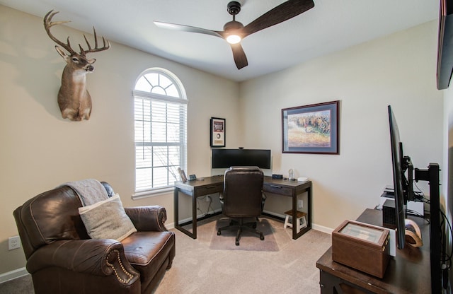 office with baseboards, a ceiling fan, and light colored carpet