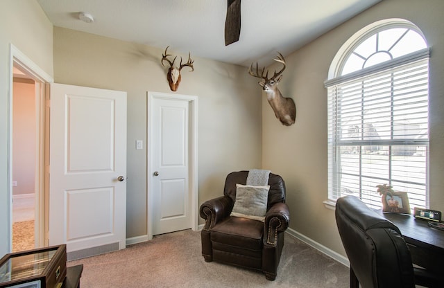 carpeted home office featuring baseboards