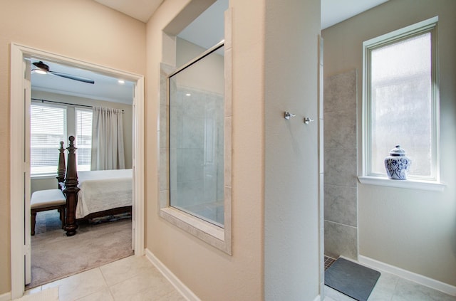 ensuite bathroom featuring ensuite bathroom, tiled shower, tile patterned flooring, and baseboards