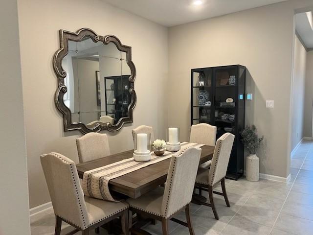 tiled dining room with baseboards