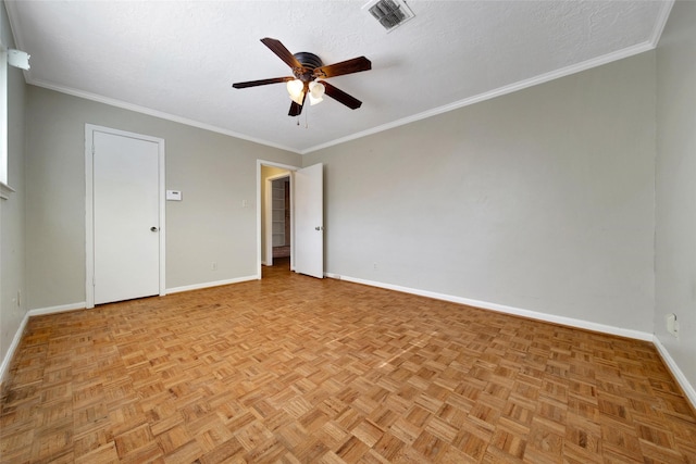 unfurnished room with crown molding, visible vents, ceiling fan, and baseboards