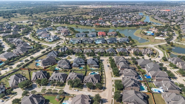 birds eye view of property featuring a water view and a residential view