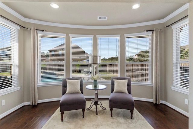 living area featuring ornamental molding, visible vents, baseboards, and hardwood / wood-style flooring