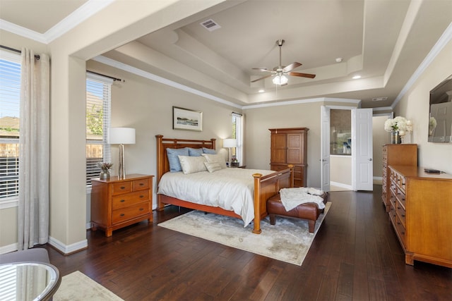 bedroom with visible vents, a raised ceiling, and dark wood finished floors