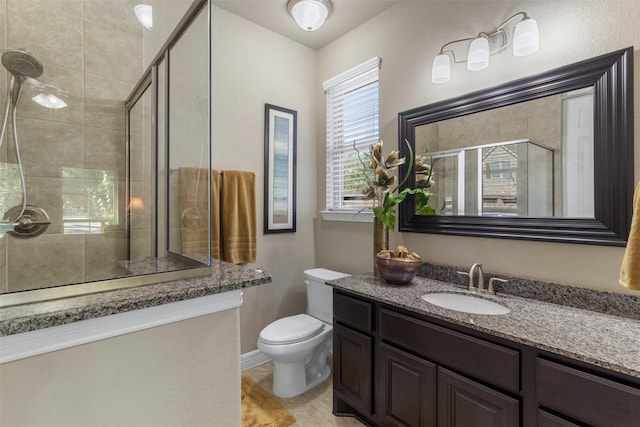 full bathroom featuring a stall shower, vanity, and toilet