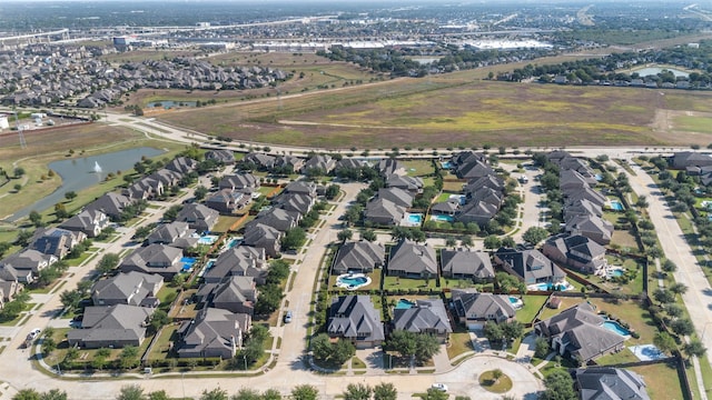 birds eye view of property with a water view and a residential view