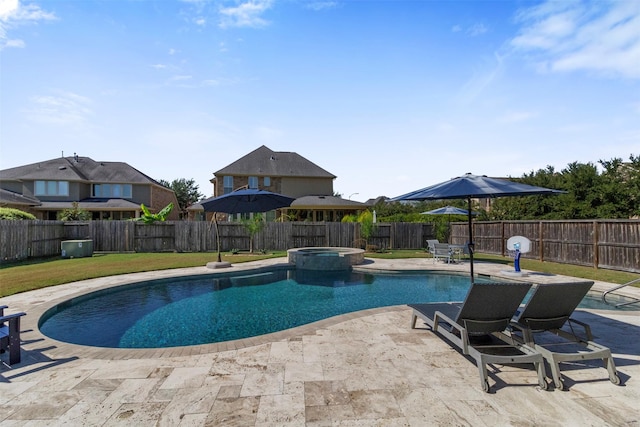 view of pool with a patio area, a fenced backyard, a pool with connected hot tub, and a lawn