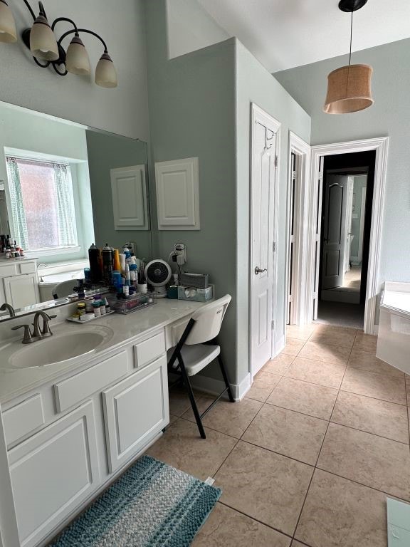 full bathroom with vanity, baseboards, and tile patterned floors