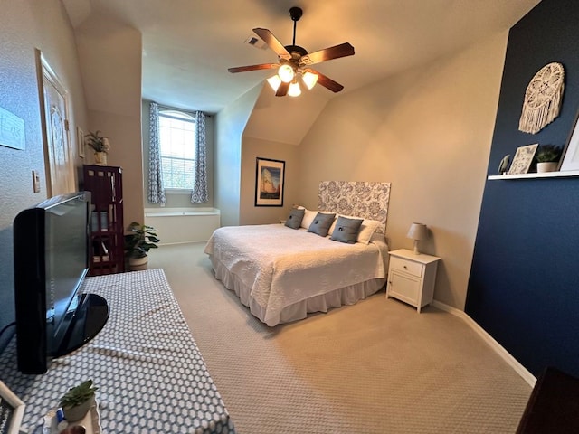 bedroom featuring light carpet, a ceiling fan, visible vents, vaulted ceiling, and baseboards