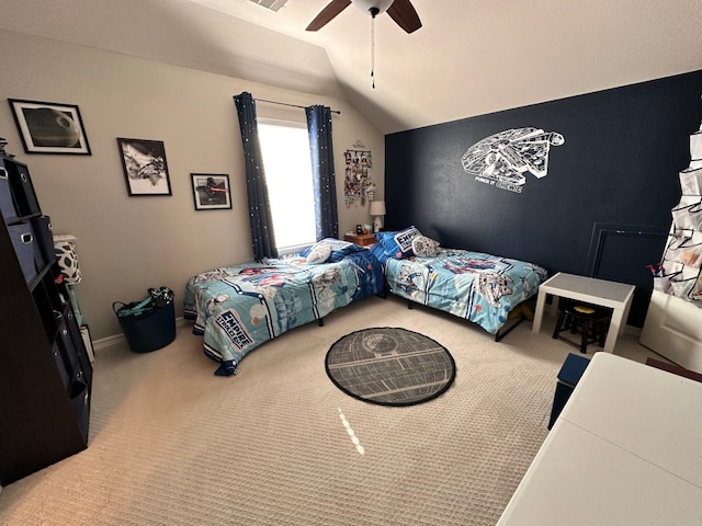 carpeted bedroom with baseboards, visible vents, vaulted ceiling, and a ceiling fan