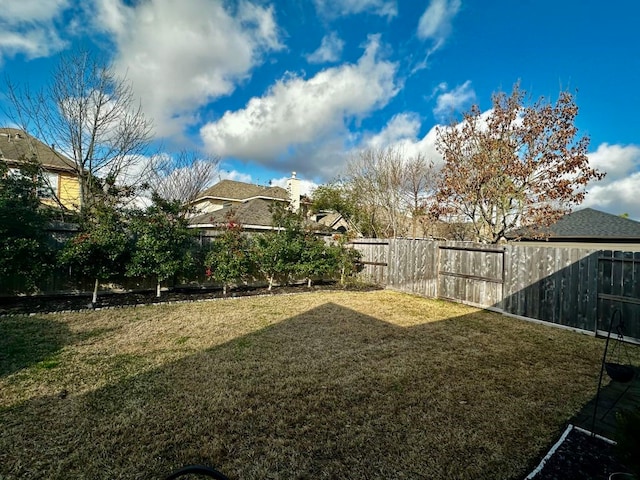 view of yard with a fenced backyard