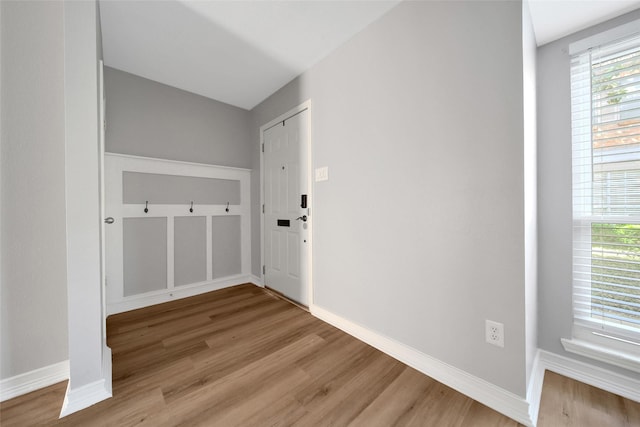 interior space with baseboards and wood finished floors