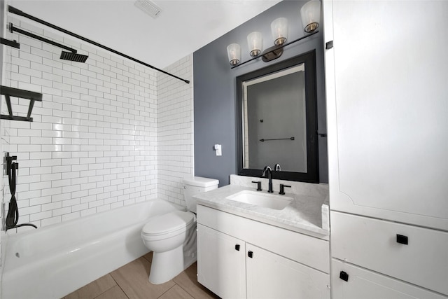 bathroom featuring toilet, washtub / shower combination, visible vents, and vanity