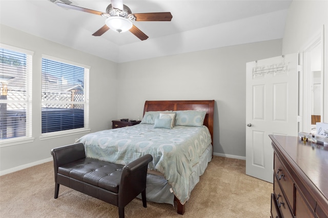 bedroom featuring light carpet, ceiling fan, baseboards, and lofted ceiling