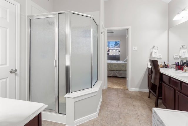 8707 Rolling Rapids Rd, Humble, TX 77346 - full bathroom with vanity, a shower stall, ensuite bathroom, tile patterned floors, and baseboards