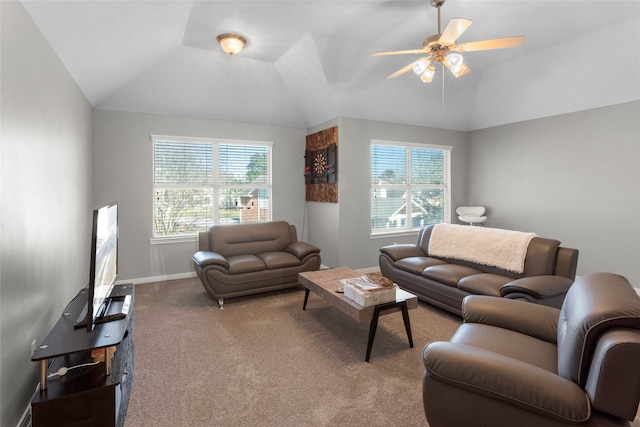 carpeted living area with plenty of natural light, baseboards, vaulted ceiling, and a ceiling fan