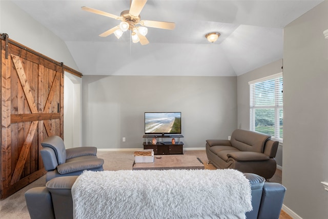 living room with lofted ceiling, a barn door, carpet flooring, and a ceiling fan