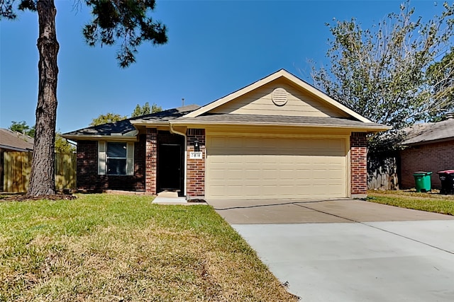 ranch-style home featuring a front yard, concrete driveway, brick siding, and an attached garage