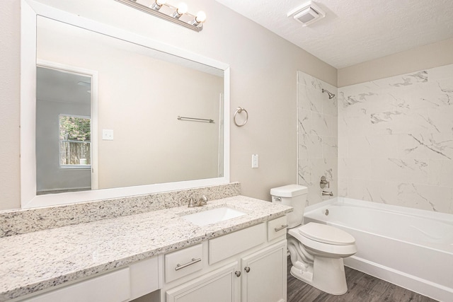 24134 Griffin House Ln, Katy, TX 77493 - bathroom with vanity, wood finished floors, bathing tub / shower combination, and a textured ceiling